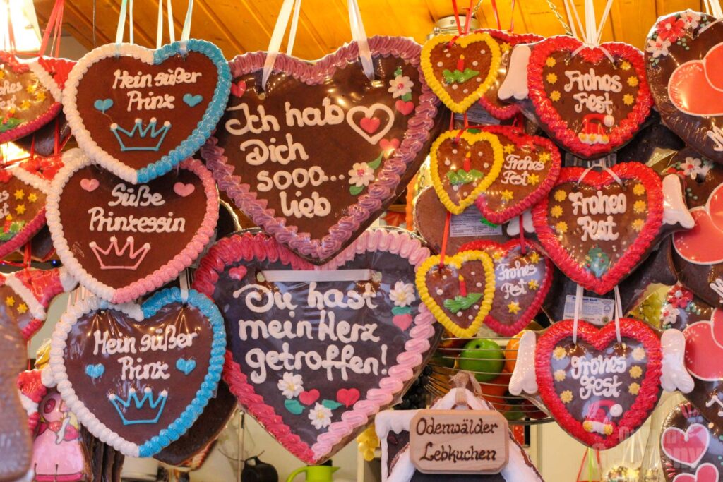 Many Lebkuchen hearts hanging in a Christmas market food stall in Germany