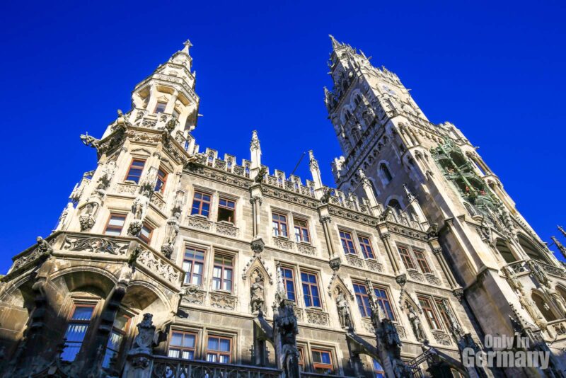 Marienplatz in Munich, Germany - close up of a huge building and two big towers and clear blue sky in the background